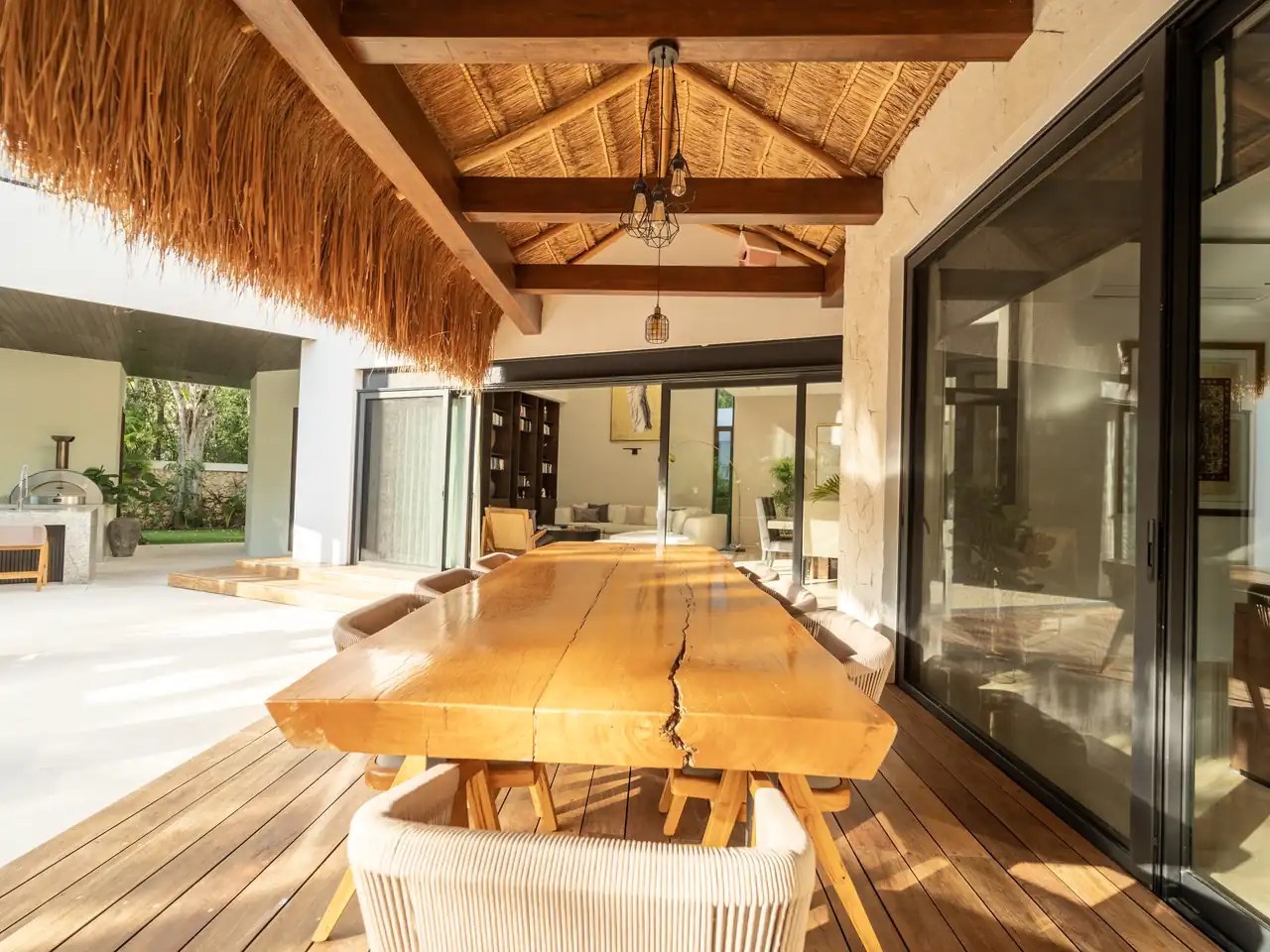 Palapa dining terrace of a finished home with a pool and jungle garden
