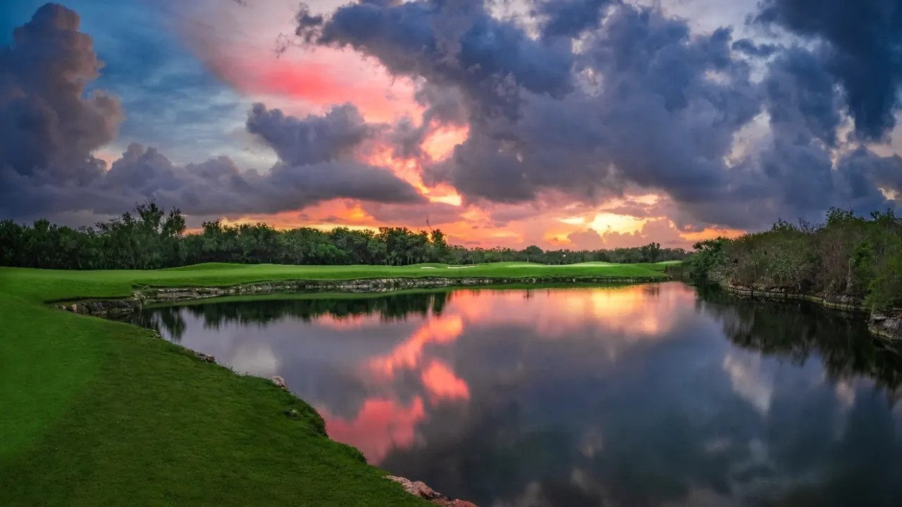 Golf course and lake at sunset